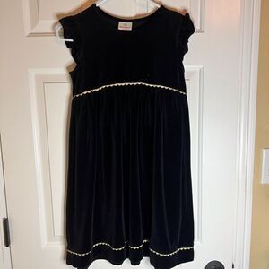Hanna Andersson Black and‎ Gold Ruffle Dress.  Gold trim has sparkle. Size 150.